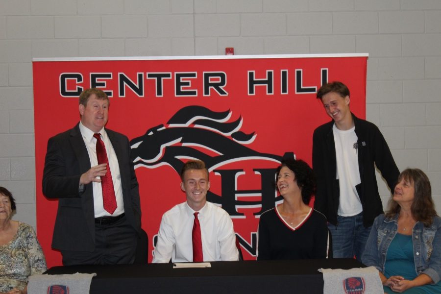 Joseph Wilkerson, standing at left, speaks at his son Jacobs signing ceremony on Nov. 7. A left back for the Mustangs, Jacob Wilkerson will play soccer for Itawamba Community College next year.