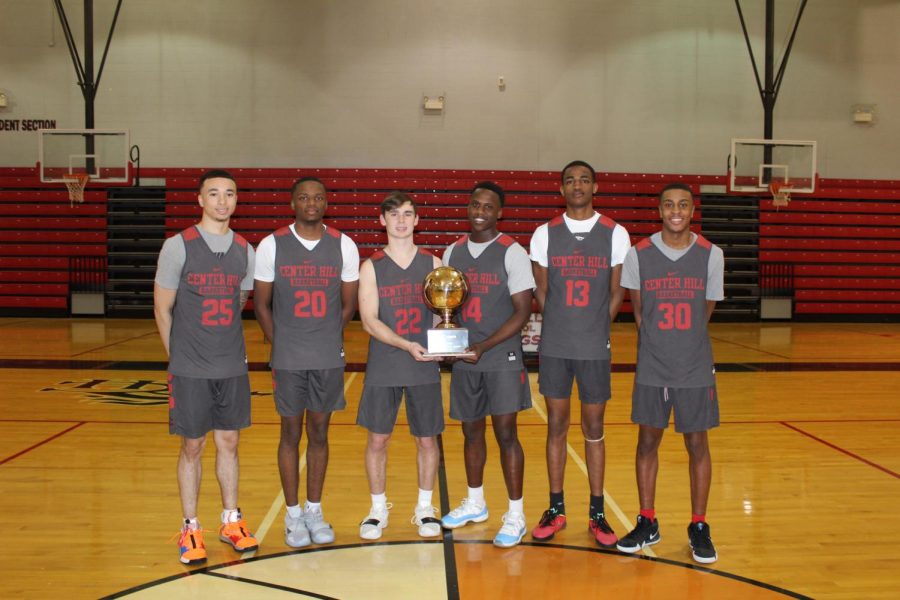 Wearing their practice jerseys, seniors Calvin Temple, Kevin Henry, Cameron Goodwin, Marquez Berry, Antwan Honer and Kenneth Lewis pose with the Gold Ball trophy they brought home March 8 after defeating district rivals Olive Branch 75-73 in the Class 5A State Championship. The win at the Big House in Jackson marks the first state basketball title in school history.