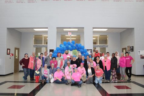 The staff at Center Hill High School surprised teacher Ginny Shikle, seated at center, by wearing scarves, caps and chemo beanies. At the end of the day, Shikle was given 25 head coverings to wear as she battles breast cancer.