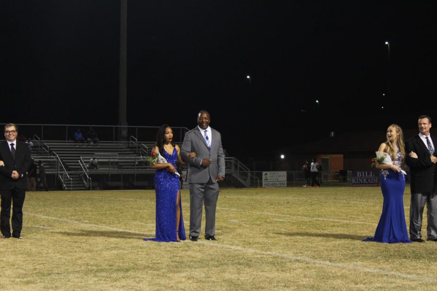 Kennedi Evans reacts to being named Homecoming Queen during halftime of the Sept. 13 game against Douglass High School. I guess I had just prepared myself that I wasnt going to win and it really threw me off guard, she said. Junior maid Billie Boyd is pictured at right.