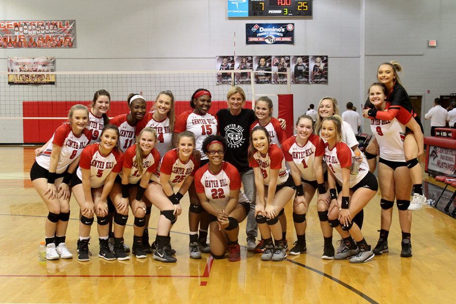 Coach Robbie Veazey, center of back row, poses with her team following their 3-0 sweep of Saltillo (25-14, 25-7, 25-7) in round one of volleyball playoffs on Oct. 17. The Mustangs travel to Cleveland Central for their next playoff game Oct. 22. 