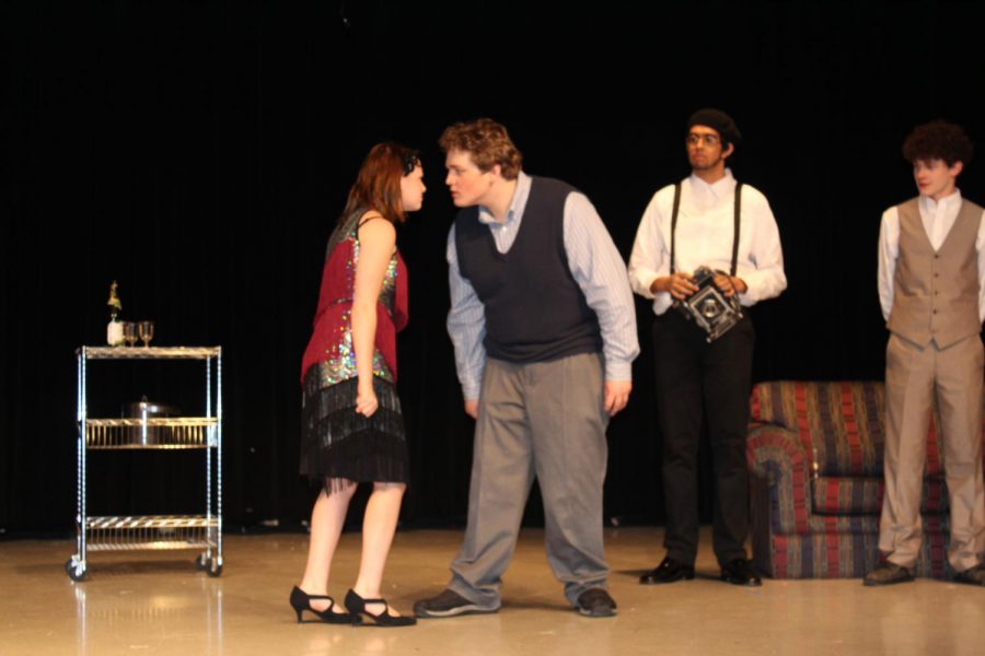 Myrtle Wilson, portrayed by Madison Spivey, and Tom Buchanan, played by Jacob Money, argue in a scene during a dress rehearsal of The Great Gatsby. Jose Esquivel as Chester McKee and Caleb Jenkins as Nick Carraway are also pictured. Performances will be Dec. 12-14.