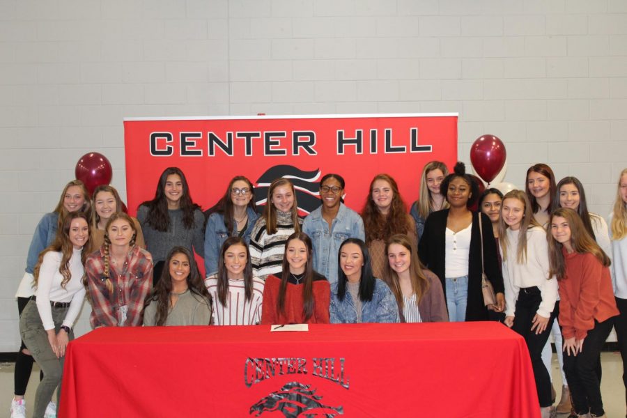 Surrounded by her teammates, Maggie Gaines signed today to play soccer at Hinds Community College. Gaines is a co-captain and midfielder for the Lady Mustangs.