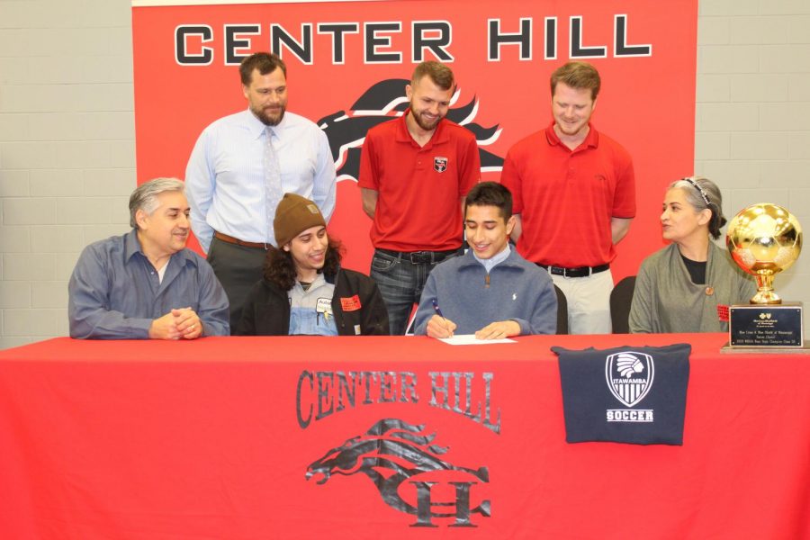 With his family, Principal Doug Payne and coaches Blake Lashlee and Andrew Yeoman looking on, Diego Valenzuela signed today to play soccer at Itawamba Community College. Valenzuela scored the winning goal Feb. 8 in Center Hills 2-1 defeat of Long Beach for the Class 5A state championship.