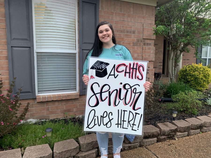 Sarah Hennan holds a yard sign that her mom made for the seniors upcoming graduation. Originally scheduled for 10 a.m. Saturday, May 23 at the Landers Center, CHHS graduation is now up in the air because of the coronavirus. One option being considered is holding a traditional commencement later in the summer. 