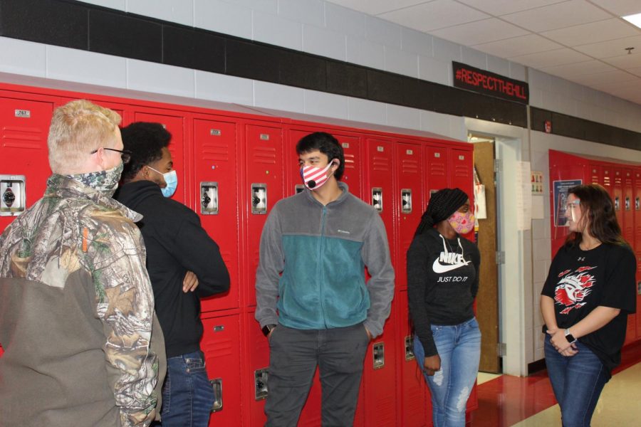 Students have many options for face coverings to protect themselves and others during the pandemic. From left, junior Nicholas Minott wears a neck gaiter, junior Lawrence Jones wears a surgical mask, junior Omar Almuntaser wears an N95 mask, sophomore Jamya Hassell wears a cloth mask, and sophomore Lorie Buckley wears a clear face shield.