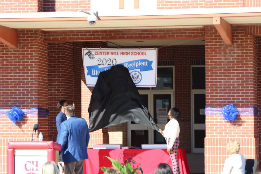 Principal+Doug+Payne+looks+on+as+seniors+Zandon+Haralson%2C+left%2C+and+Candice+Buford+unveil+the+National+Blue+Ribbon+banner+at+the+schools+front+entrance.+%E2%80%9CIt+is+a+tremendous+honor%2C%E2%80%9D+Payne+said.+%E2%80%9CIt%E2%80%99s+a+symbol+of+excellence+that+we+will+receive+with+great+pride+and+will+display+with+great+pride.%E2%80%9D