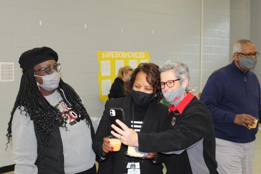 Cynthia Bobo, left, looks on as Jacqueline Wooten takes a selfie with Assistant Principal Brenda Case. Wooten was recognized as the CHHS Teacher of the Year today.