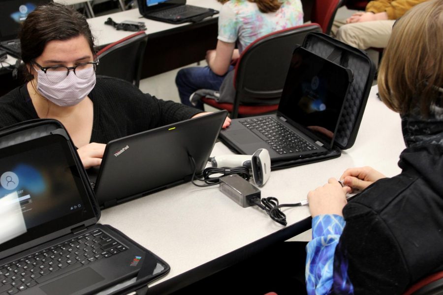 Distance Learning Team member Madeline Dormois helps set up a student laptop during one of the school’s distribution days. DeSoto County Schools purchased devices for every K-12 student with money allocated by the Mississippi Legislature.