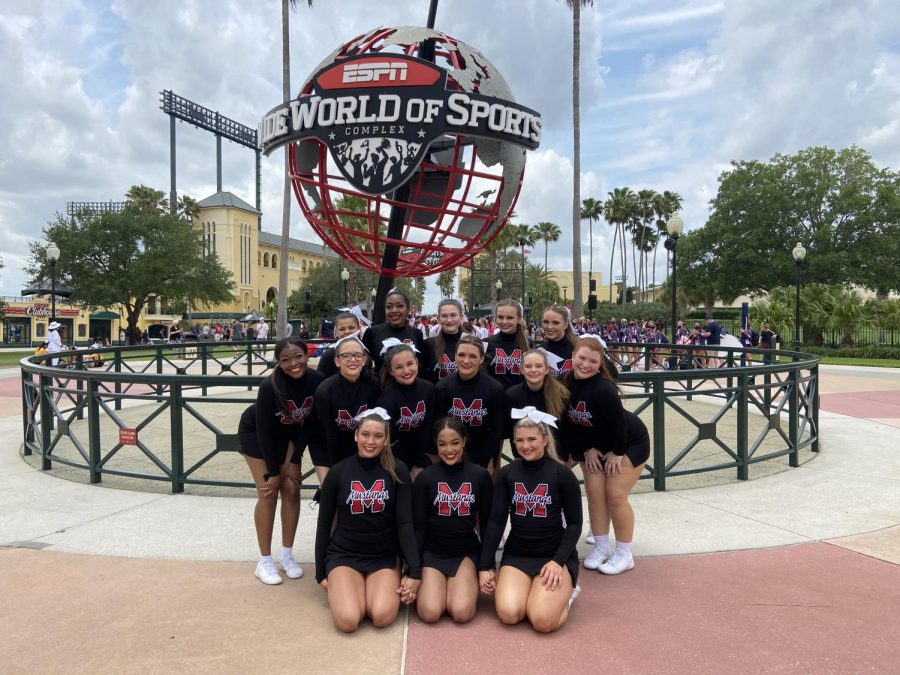 The+cheer+team+poses+in+front+of+Disney+Worlds+ESPN+Wide+World+of+Sports+Complex.+The+team+made+school+history+with+their+first+ever+top+10+finish+in+the+National+Cheerleading+Championships.