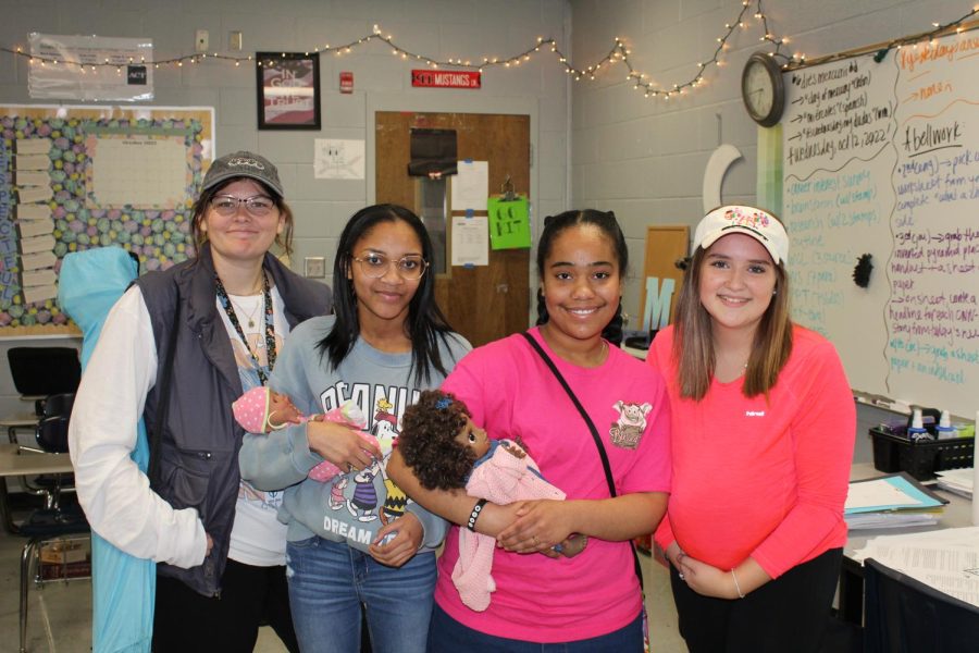 Ashtyn McAdams (left), Kyleigh Wallace (middle-left), Zahara Jamshidi (middle-right), and Stefany Sobotka (right) dress up as moms for Parents Day for HOCO week at the hill.