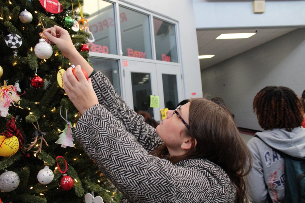 Pony Express advisor, Ashtyn Mcadams pitching in to spread holiday cheer.