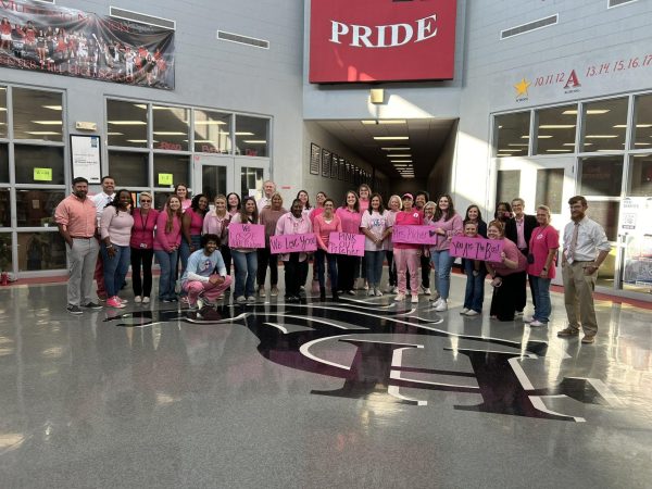 Mustangs pink-out to support teacher fighting breast cancer.